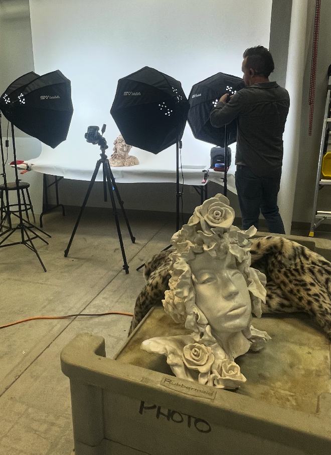 Sculptures being professionally photographed under studio lights