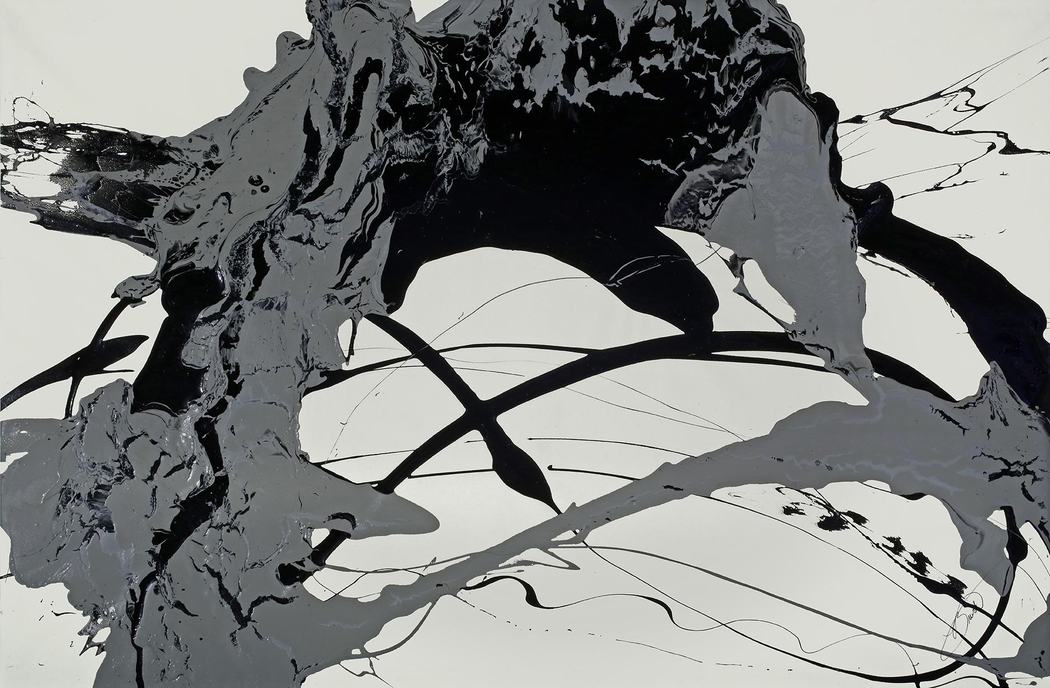 Monochrome poured paint abstract in black and gray on a pale ground